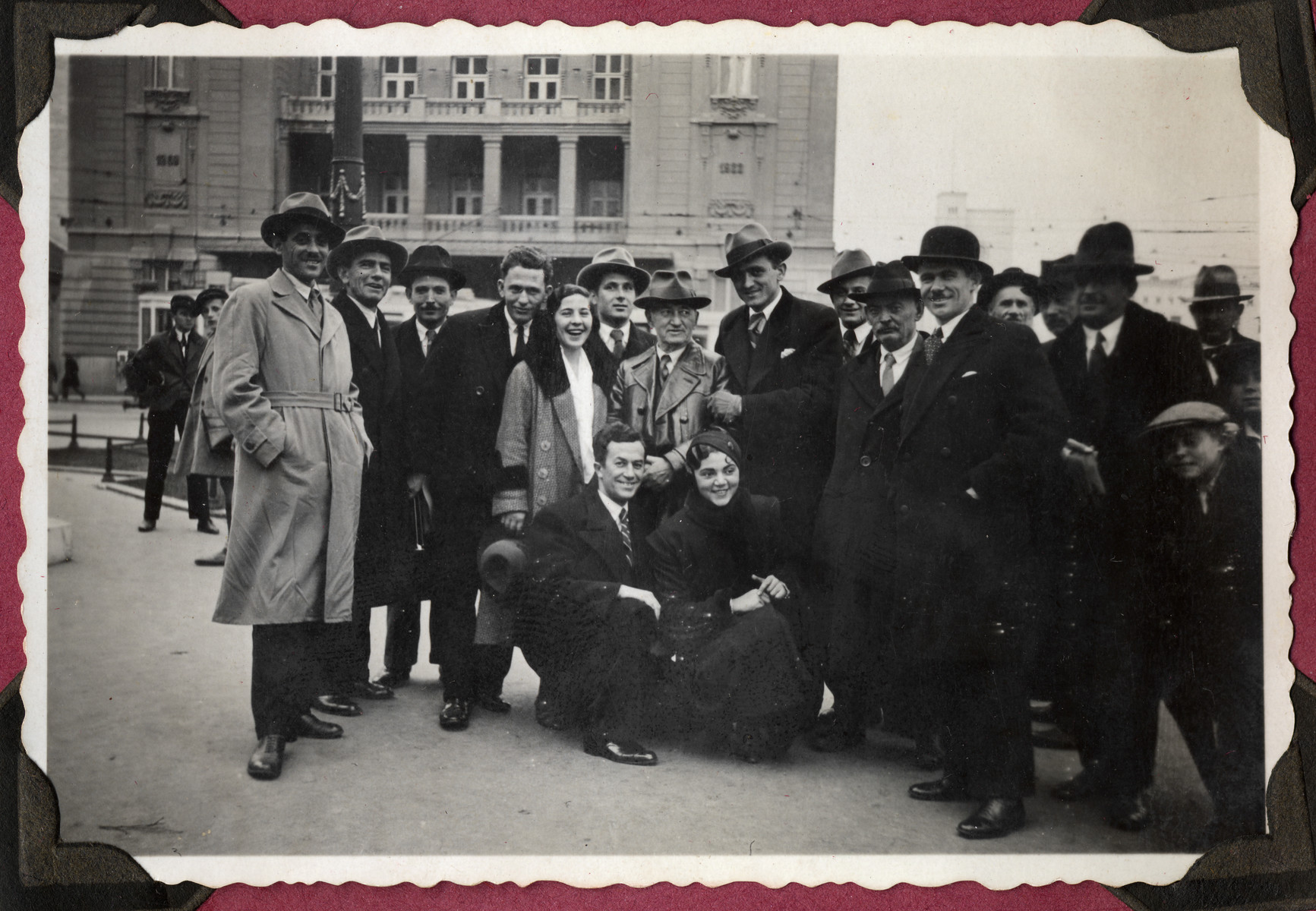 Yevrem Dragojevic, center, poses with others before an unidentified exterior.