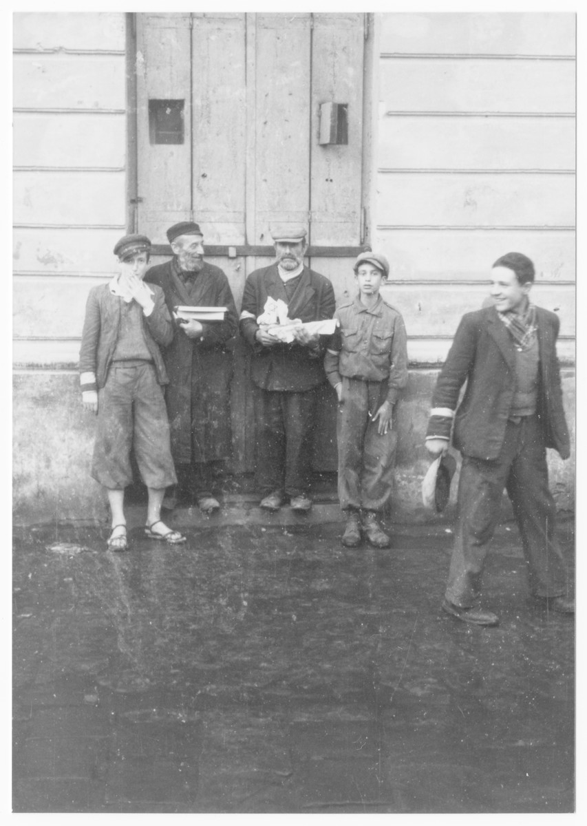 A group of Jewish men stand outside a building in the Lublin ghetto.