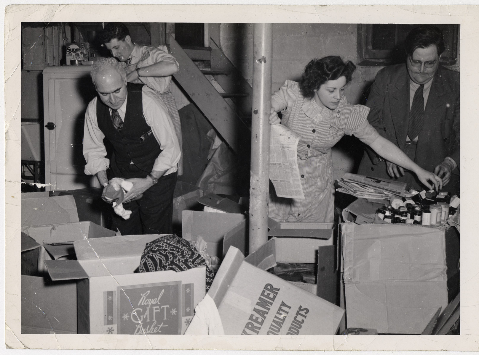 Maurice Levitt (front left) and three other members of the Frankfurt Jewish GI Council unpack boxes of supplies sent by the American Jewish community to aid displaced persons.