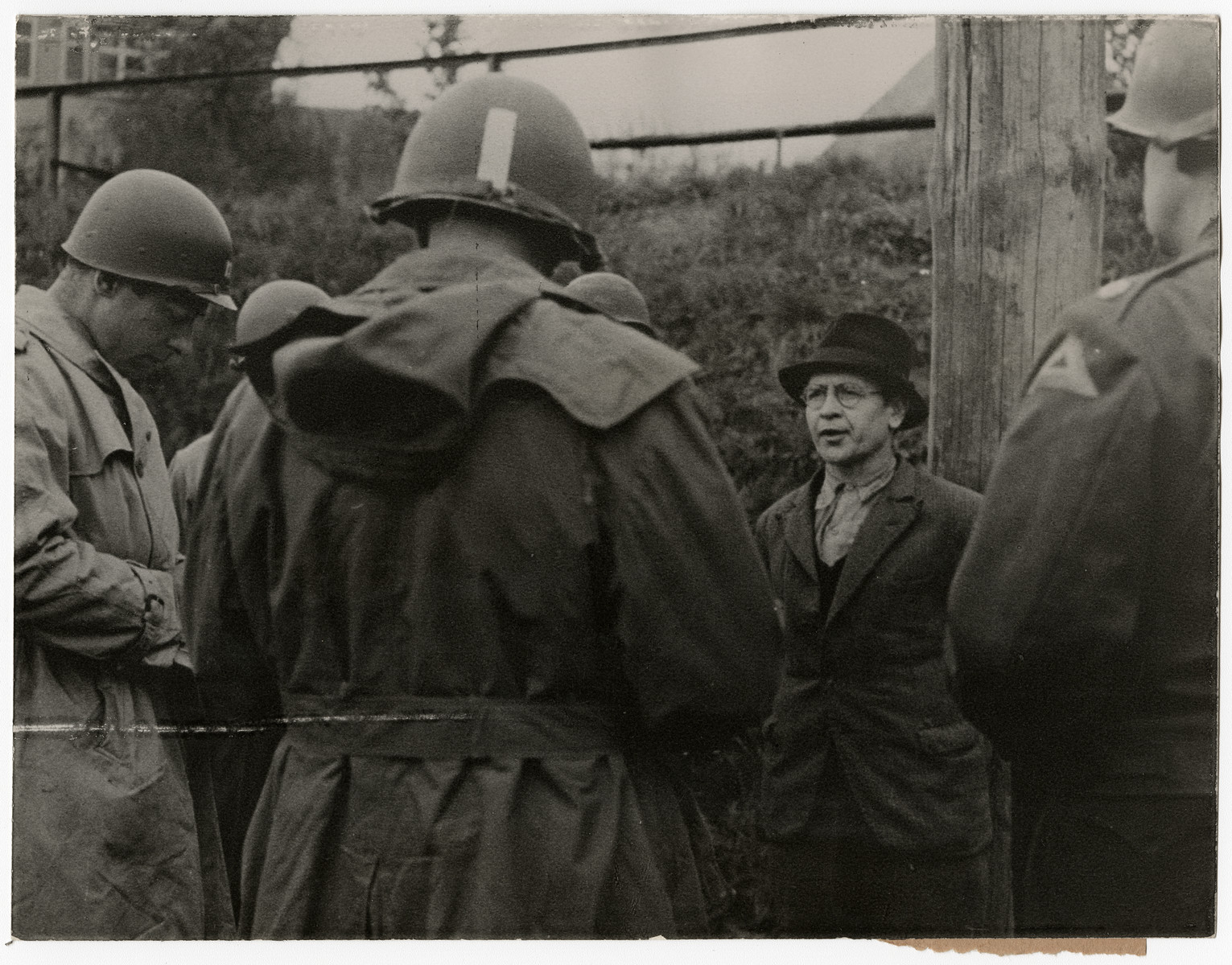 A German spy says his last words before his execution.

Original caption reads: 
Nazi Spy Shot After Military Trial
Richard Jarczyk, Nazi soldier, who became a spy in civilian clothes, was executed April 23, 1945, after court trial by a military commission of the Seventh U.S. Army. After he had discarded his uniform, Jarczyk, former member of the Volks Grenadier Division, approached U.S. Army officials and offered his services in establishing a civilian government in an occupied area of the Reich. U. S. Military authorities discovered his true role and he was brought to trial April 6, when he confessed special training for sabotage and espionage. The penalty was death by a firing squad. 

THIS PHOTO SHOWS: The doomed spy speaks his last words before being shot.