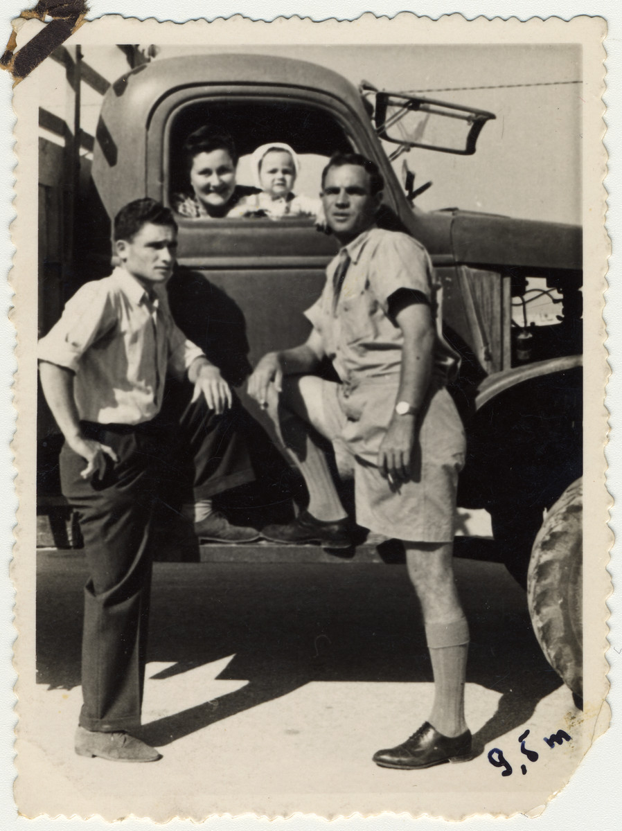 Partisan leader Zus Bielski stands next to his first truck with his wife, son, and brother in postwar Israel.

Pictured left to right are Aaron, Sonia, Yaakov and Zus Bielski.