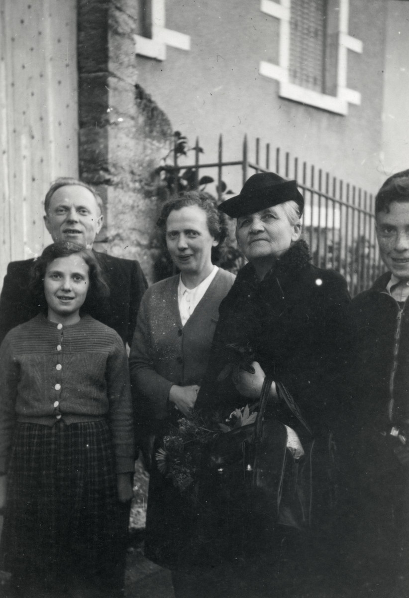 Group portrait of a Jewish family living under false papers in Vichy France.

Pictured are Hersh and Rivka Jakubovitch (left back), their children Fernande (left front) and Albert (far right), and Mm. Lanaud.