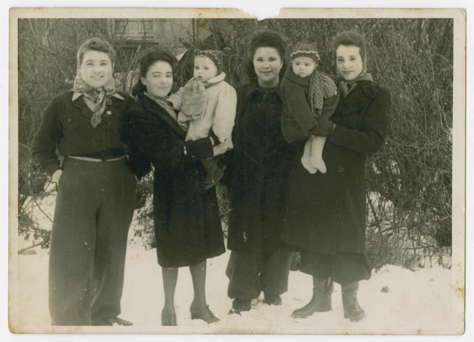 Group portrait of women, two of whom are holding their babies in the Eschwege displaced persons camp.

Pola Dichter, holding her daughter Klara, is second from the left.