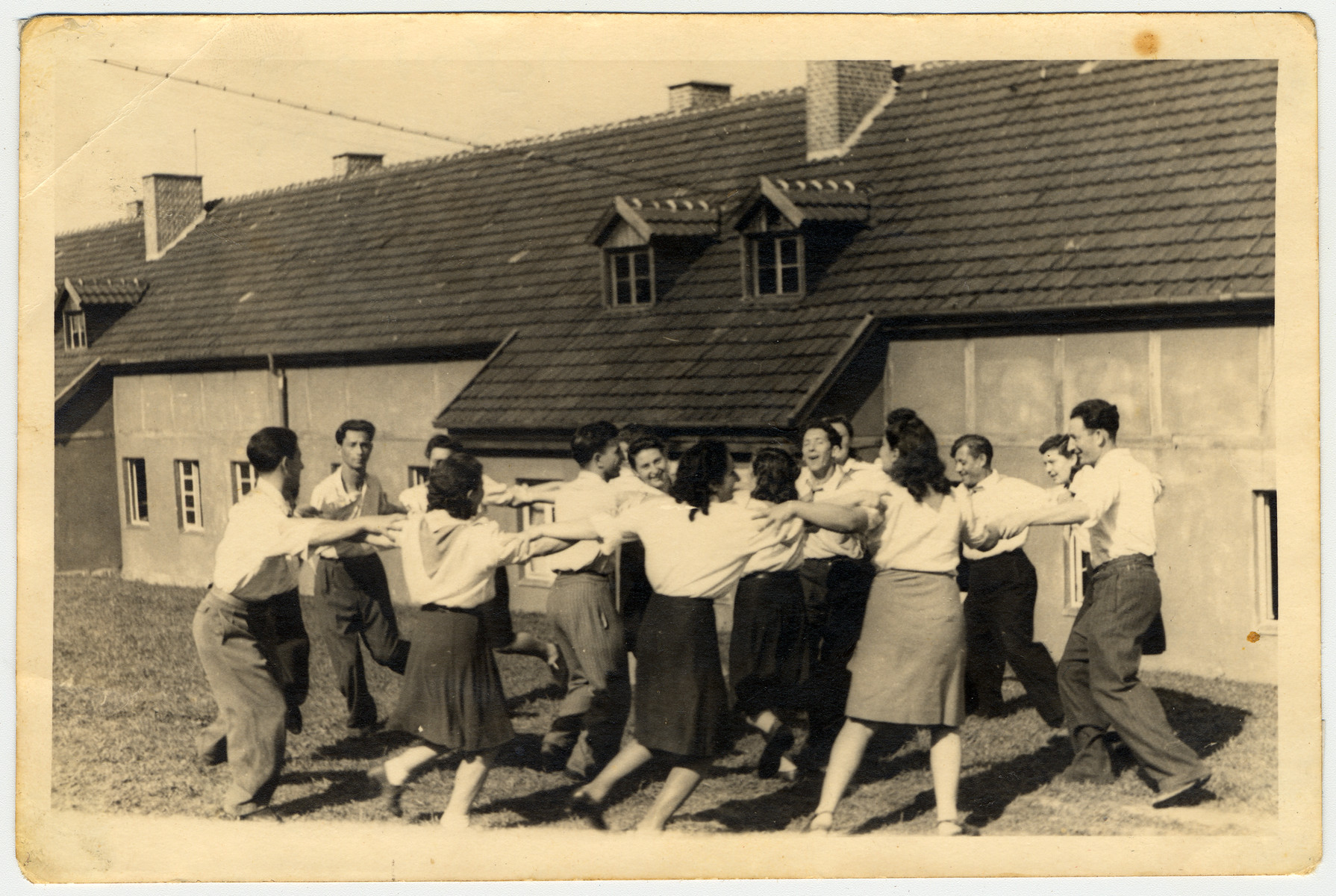 Young people dance a hora in the Kibbutz LaNegev Hachshara in the Hessisch-Lichtenau displaced persons' camp.

Among those pictured is the leader Gotek Goldring.