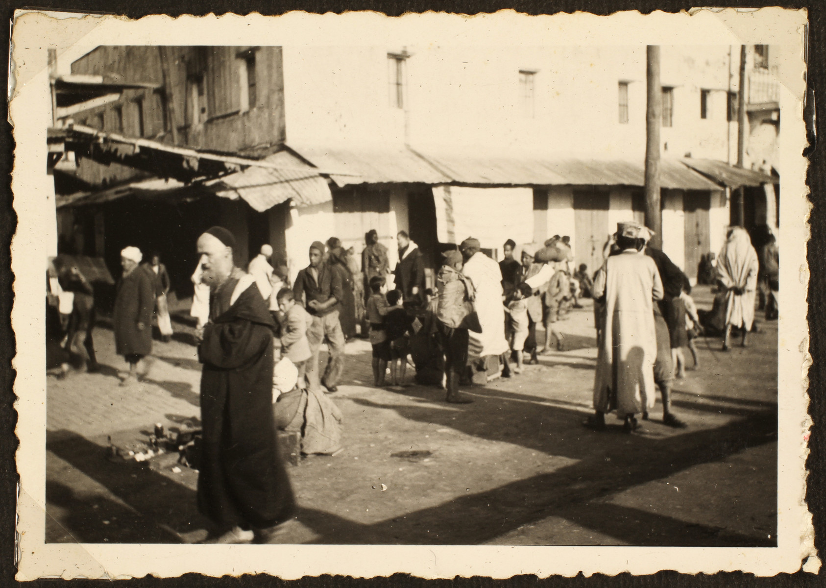Arabs and refugees walk down a street in Casablanca.