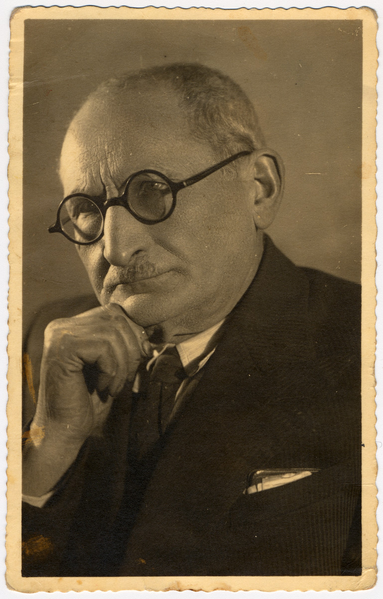 Studio portrait of Abraham Urmacher, a professor at Warsaw University and speaker of Esperanto.

Prof. Urnacher also owned the first movie studio and theater in Sciedlce, Poland as well as apartment houses, movie studios and theaters, an optic lens and
photography shop, where Shmuel Urmacher, his first born son,  mixed chemicals to develop film for amateurs and professional photographers.  (The family never received reparations for these many assets.)