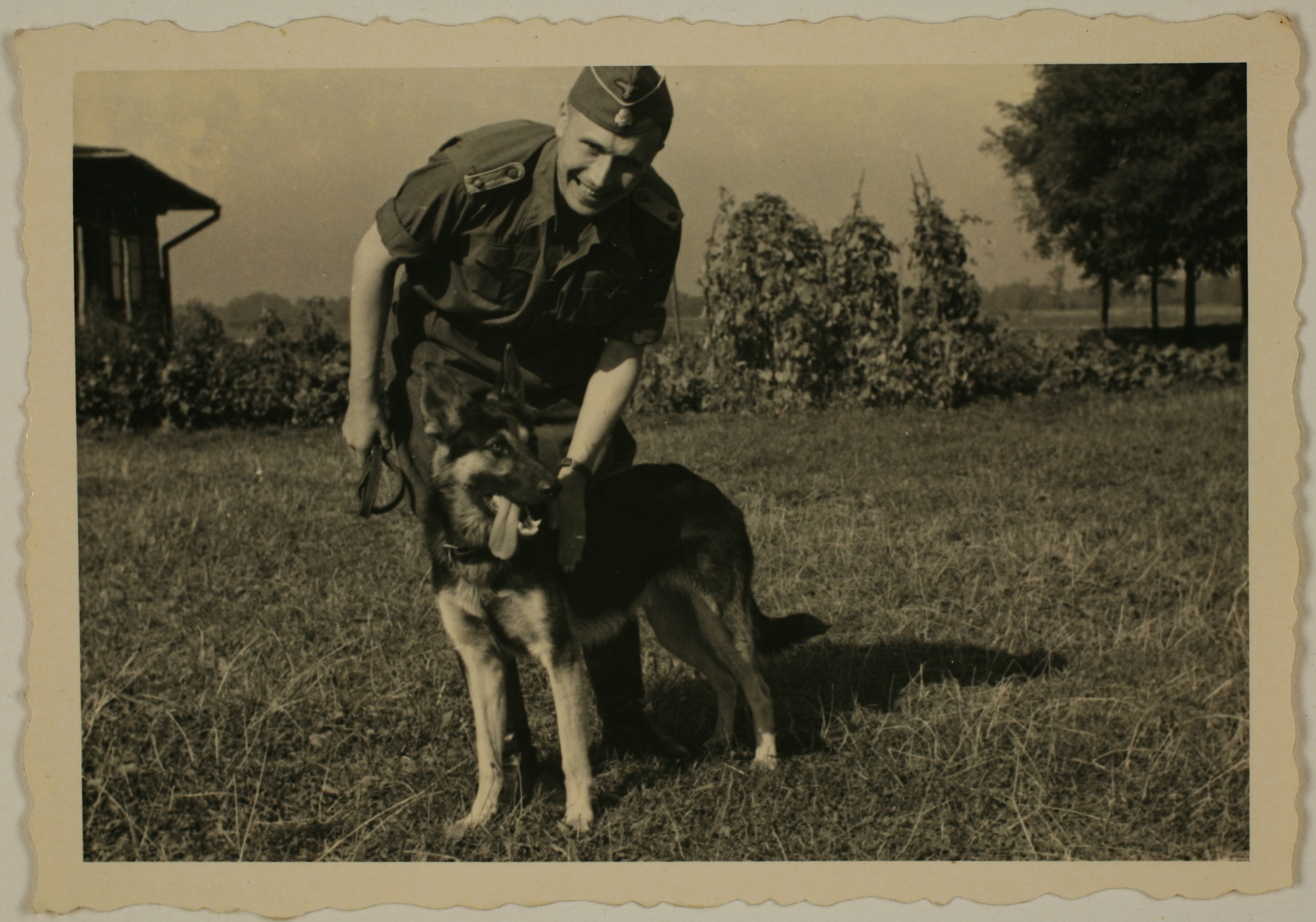 SS officer Karl Hoecker pets his dog, Favorit.