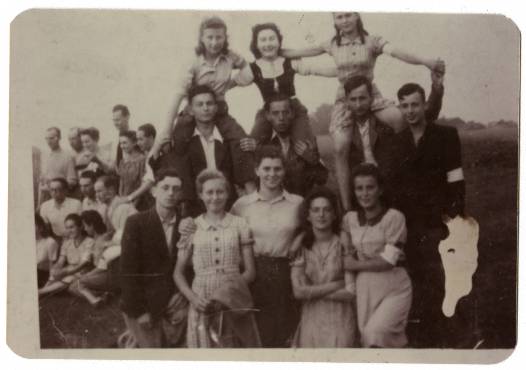 Young people wearing armbands pose in a human pyramid, probably in Dabrowa.