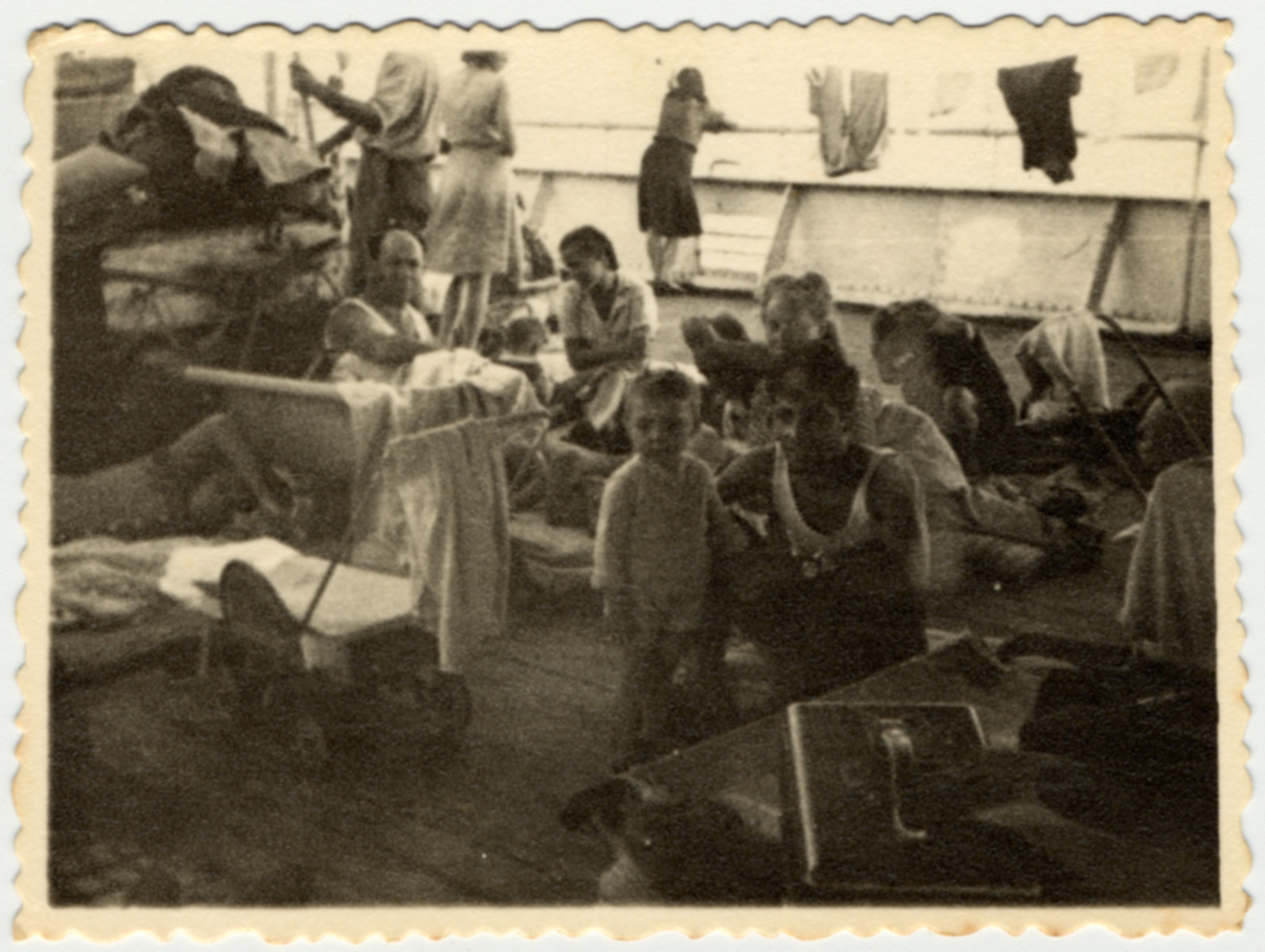 Immigrants relax on the deck of the Caserta while en route to Palestine.