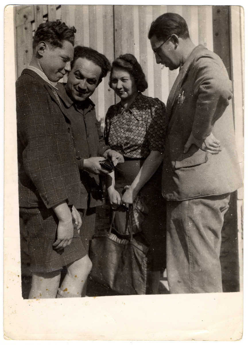 Four Jewish refugees gather in Nazi occupied France.

Pictured are Carl and Marianne Roman.  Standing between them is Mr. Schoental.