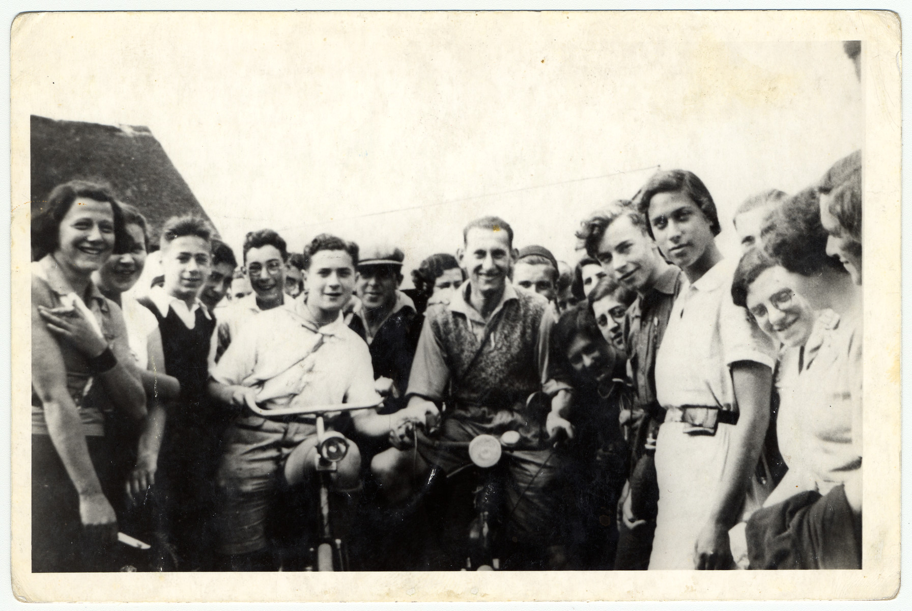 Group portrait of Zionist youth in a hachshara in The Netherlands.

Jacob Polak is pictured in the center right on a bicycle.