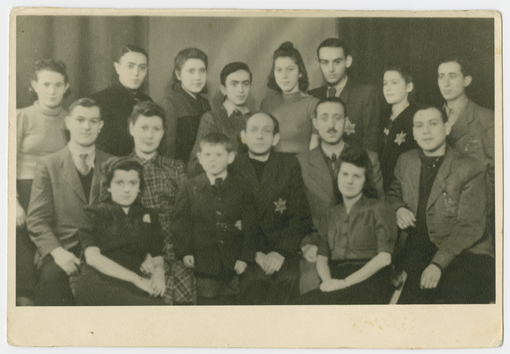 Group portrait of Jews in the Bedzin ghetto wearing the Jewish star.
          
 Among those pictured are Ruchale Hassenberg, Chaske Hassenberg and Motek Wandesan.