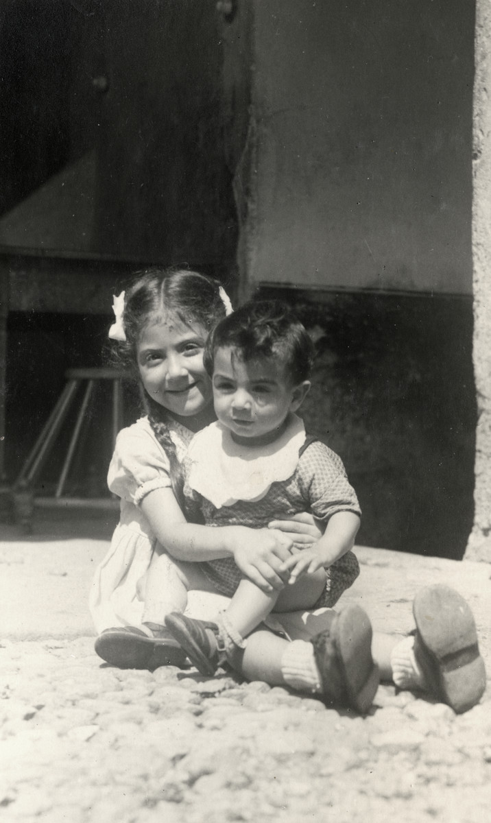 Leah Nissim holds her younger brother Daniel while in hiding with their family in Cunardo.