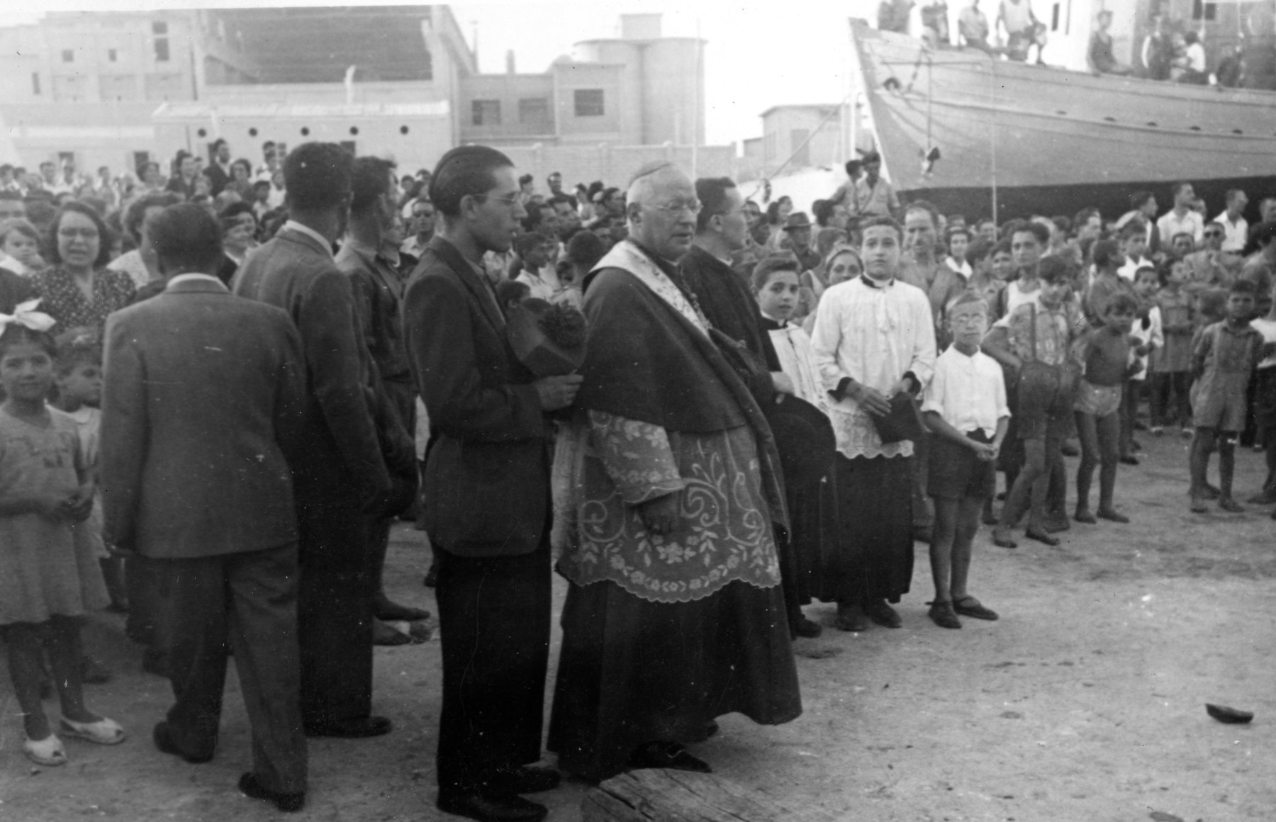 Italian priests bless the Dalin prior to its sailing from Monopoli to Palestine with 37 immigrants on board.