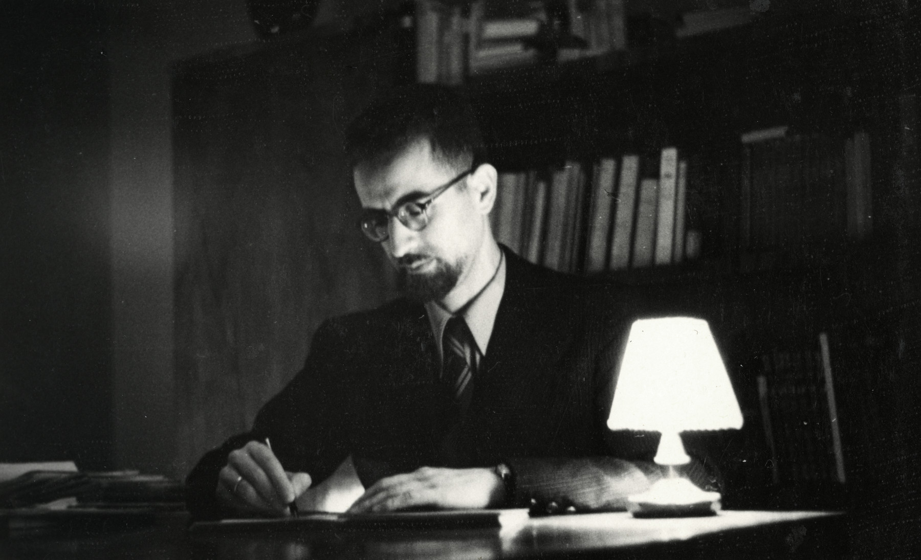 Shaul Nissim writes at his desk in Trieste.