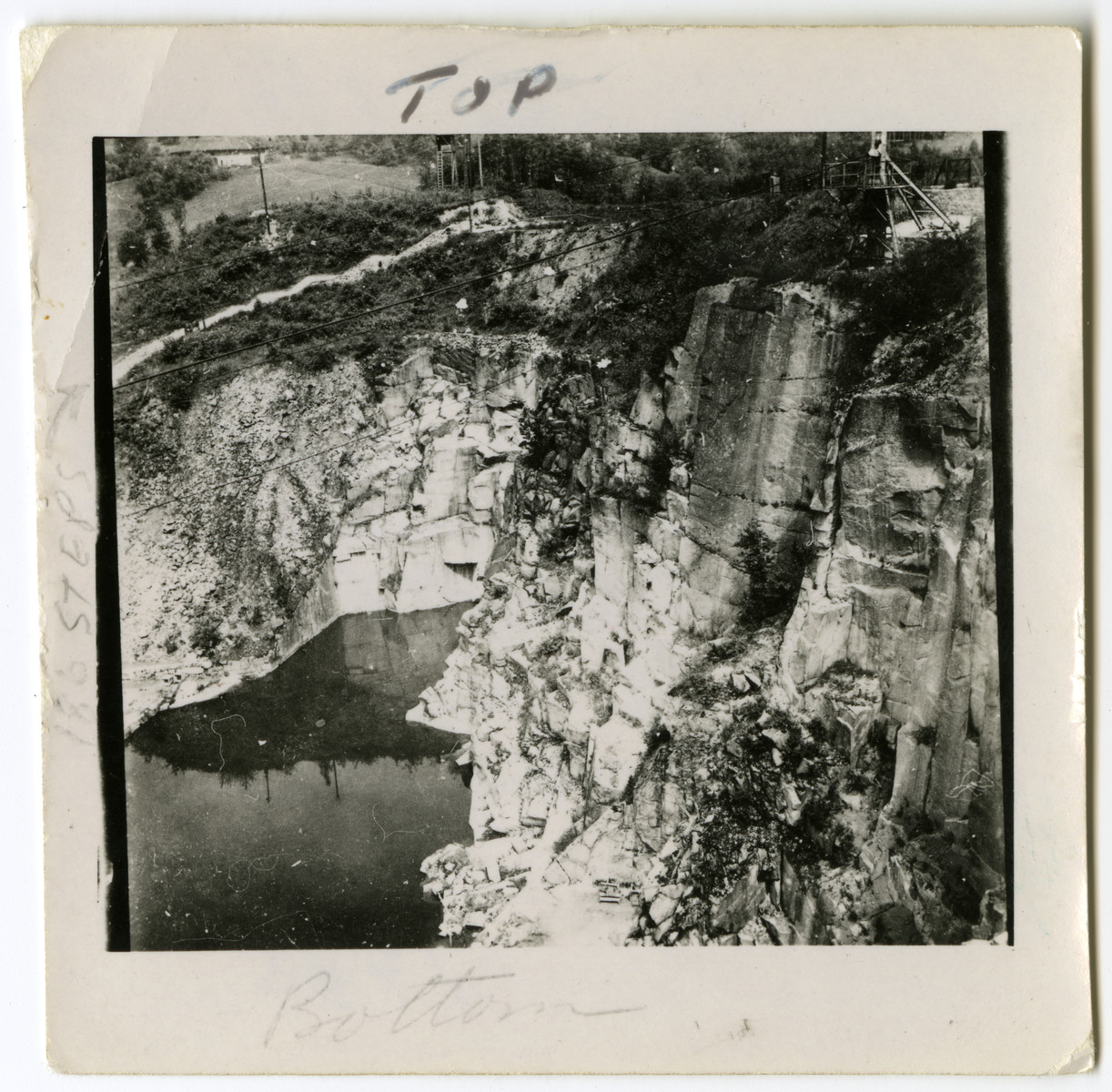 View of the stone quarry where prisoners carried heavy stones up a tall stairwell.

Original caption reads: "This is the 186 steps Nazis made prisoners half starved carry heavy loads up that white path on the left.  If they couldn't make it they whipped them.  The cliff is where they pushed them off."