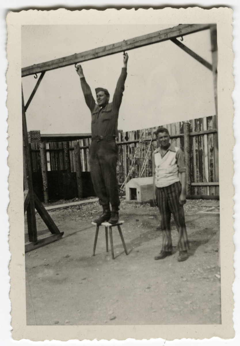 An American soldier and a survivor show the gallows at Buchenwald.

The inscription on the back of the photograph reads, "Here's where they hang them at Buchenwald Concentration Camp.  Ropes gone."