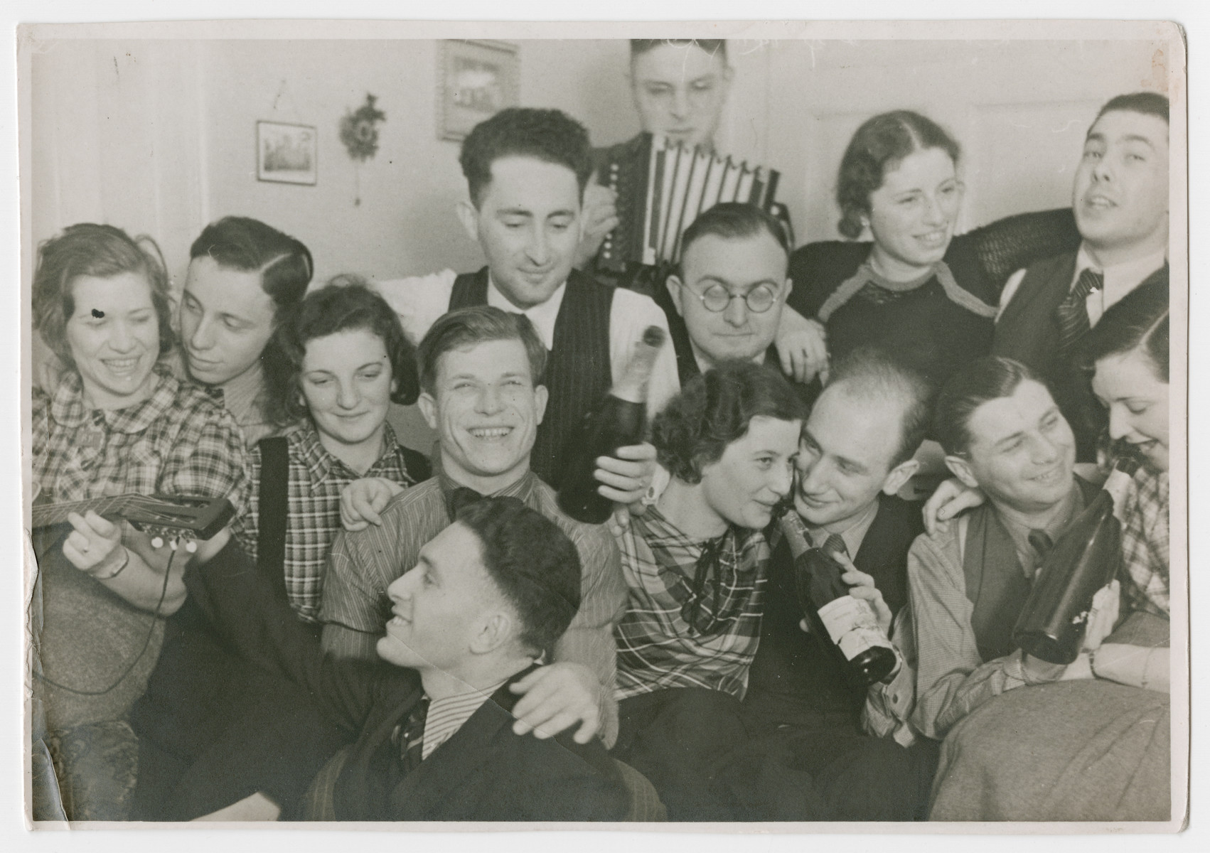 Jewish youth leaders celebrate with an accordion and bottles of champagne at a party in Mannheim.

Eric Sonnenmann is pictured in the center holding a bottle.