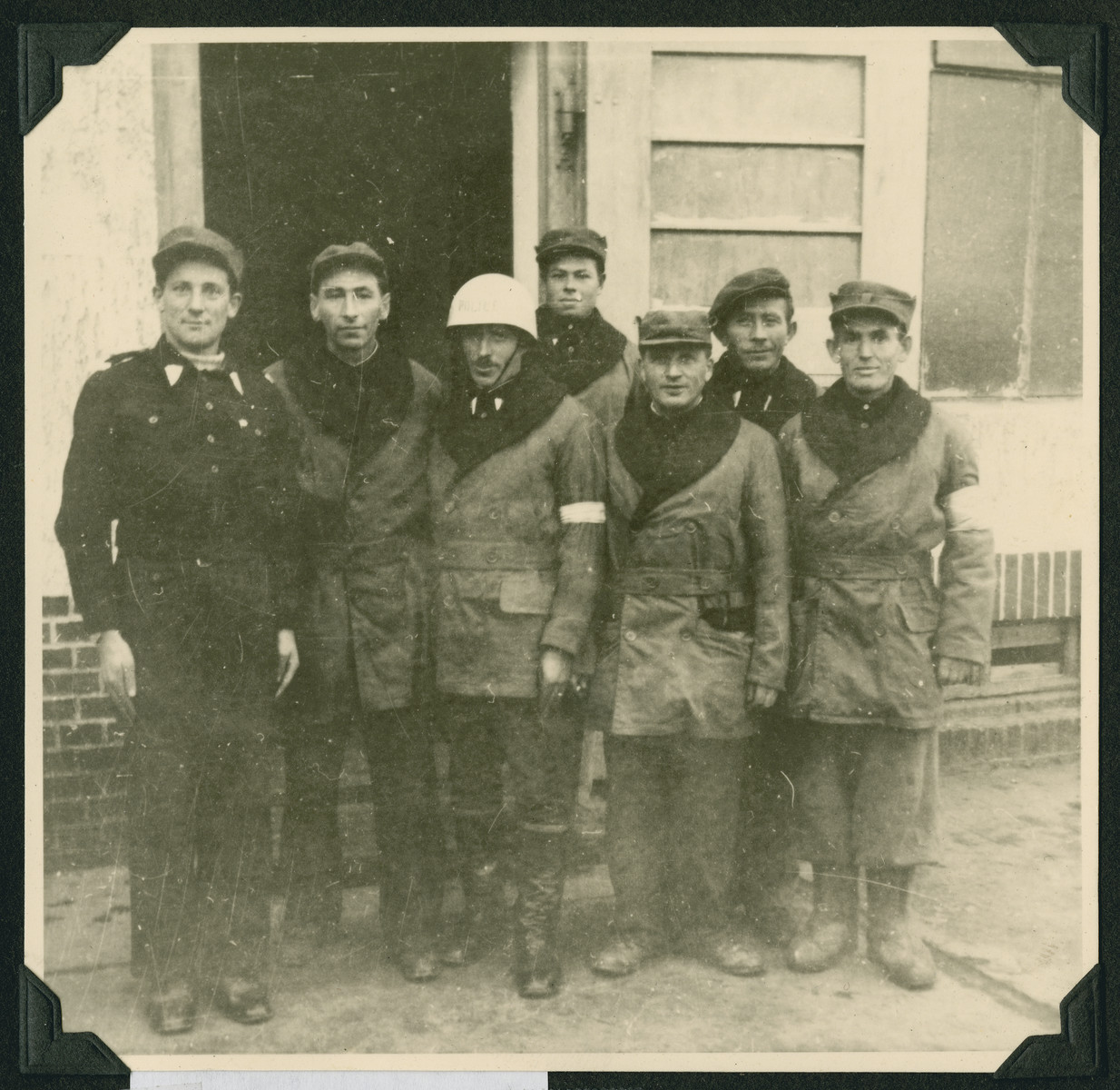 Group portrait of men, including Jewish police, in the Wetzlar displaced persons camp.