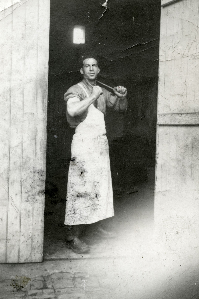Marcel Michel stands by the entrance to his butcher shop.