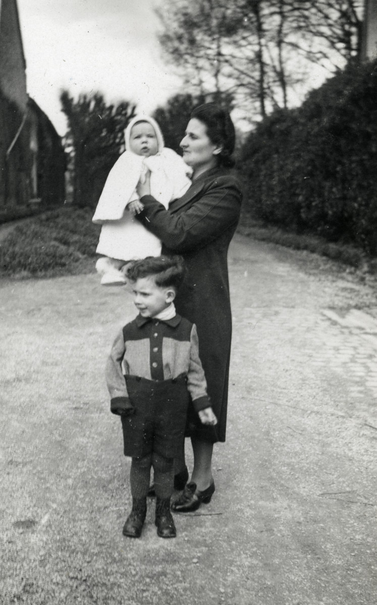 Suzanne Michel, holding her baby Marc, stands with her oldest son Jacques after crossing into Free France.