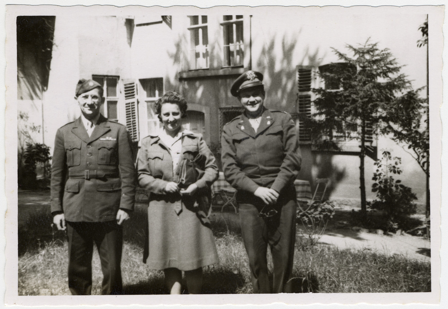 Portrait of three UNRRA staff members.

Mordecai Schwartz is on the left.  The original caption reads: "Military Mission to Camp"