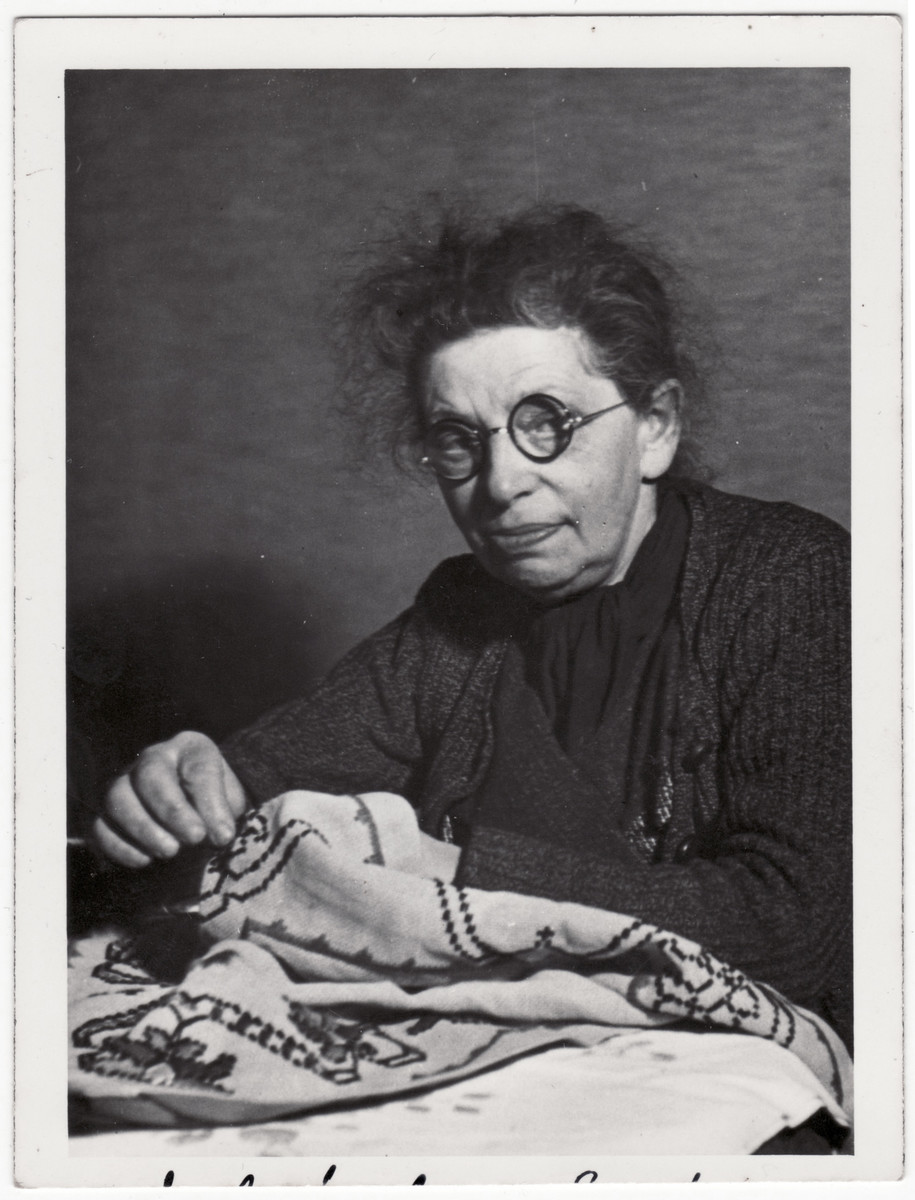 Adele Bassfreund, the sister of Ismar Bassfreund, embroiders a cloth.