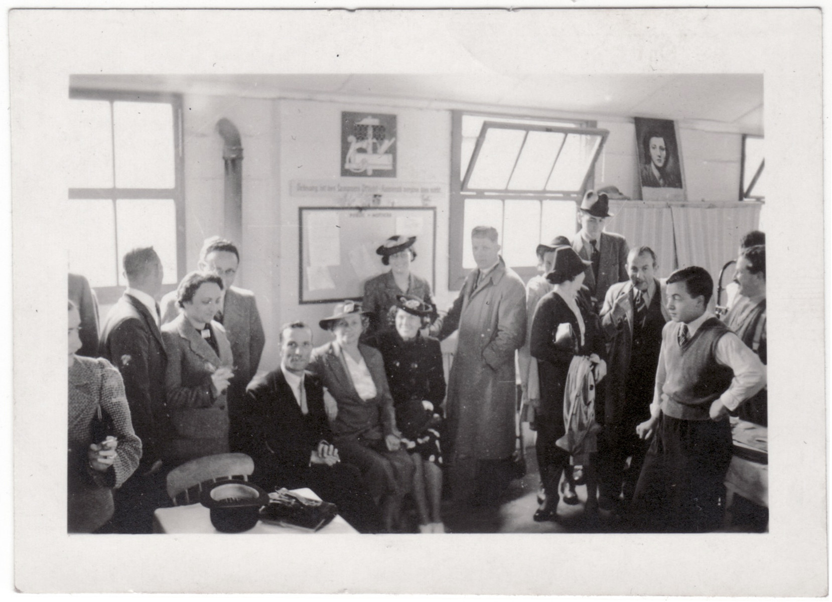 Jewish refugees gather and socialize inside a building of the Kitchener refugee camp.

Among those pictured are Sydney Kulmann (third from the right facing the camera) and [possibly his fiancee Marion Bassfreund] next to him.