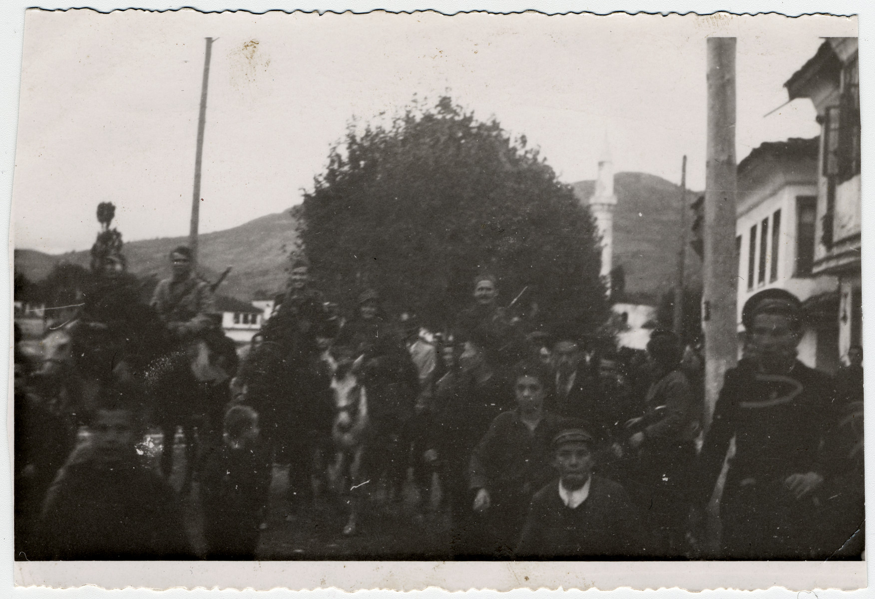 Partisans ride into the newly--liberated town of Struga, in southwestern Macedonia. 

Among those pictured are Jamila Kolonomos (center, on horseback) and Chede Filipovski (first on the left).
