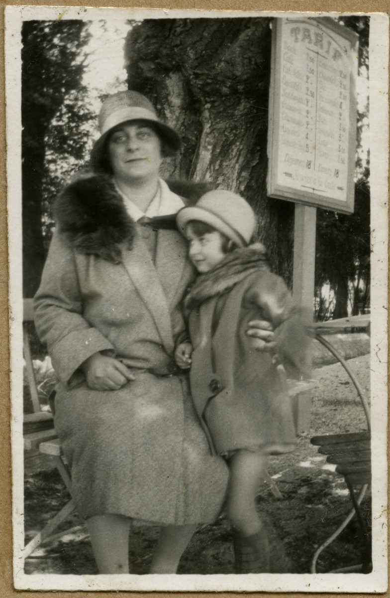 Andree Caraco and her daughter Denise Caraco pose on a bench in a public park.