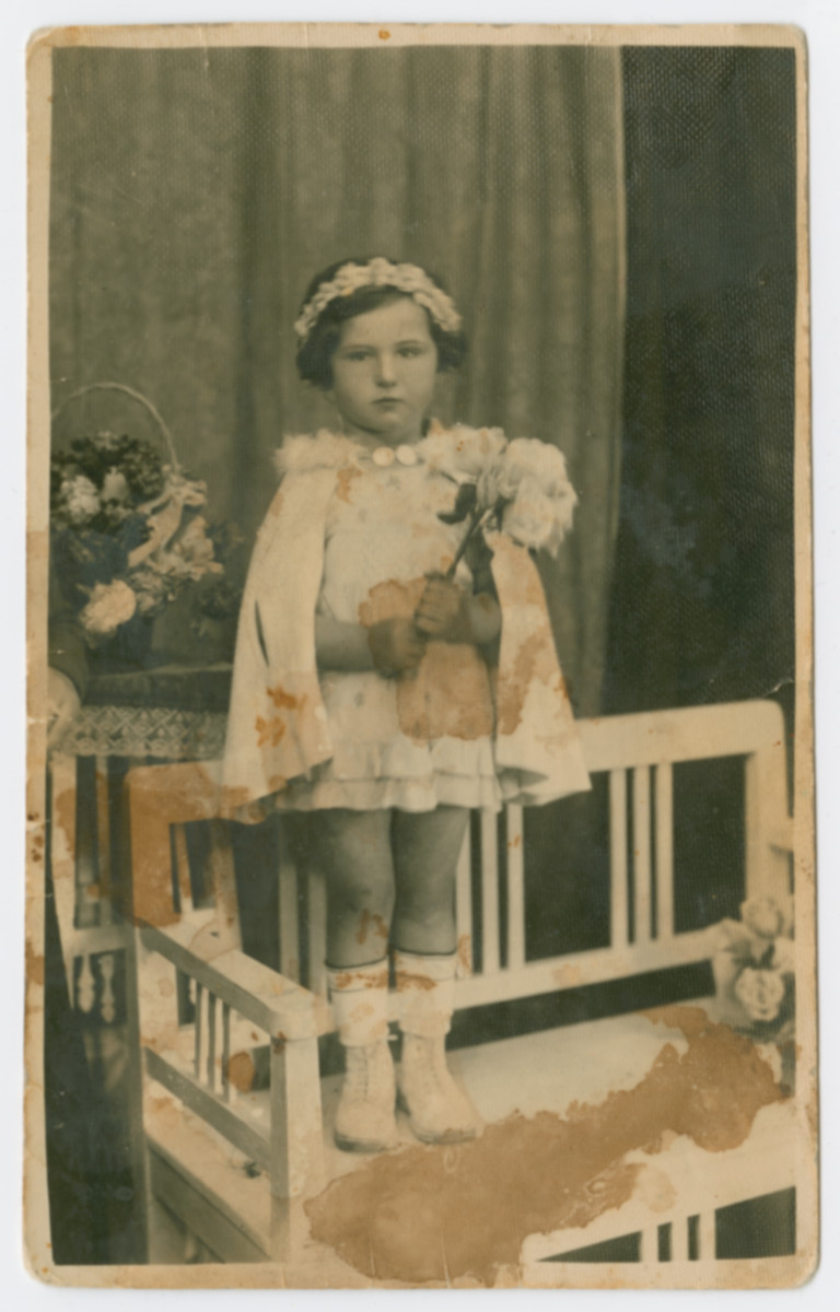 Portrait of Lili Katz taken on Purim only months before she was murdered at Auschwitz.

Lili was the daughter of Friderika Klein's cousin.  She was about five years old when she was killed.