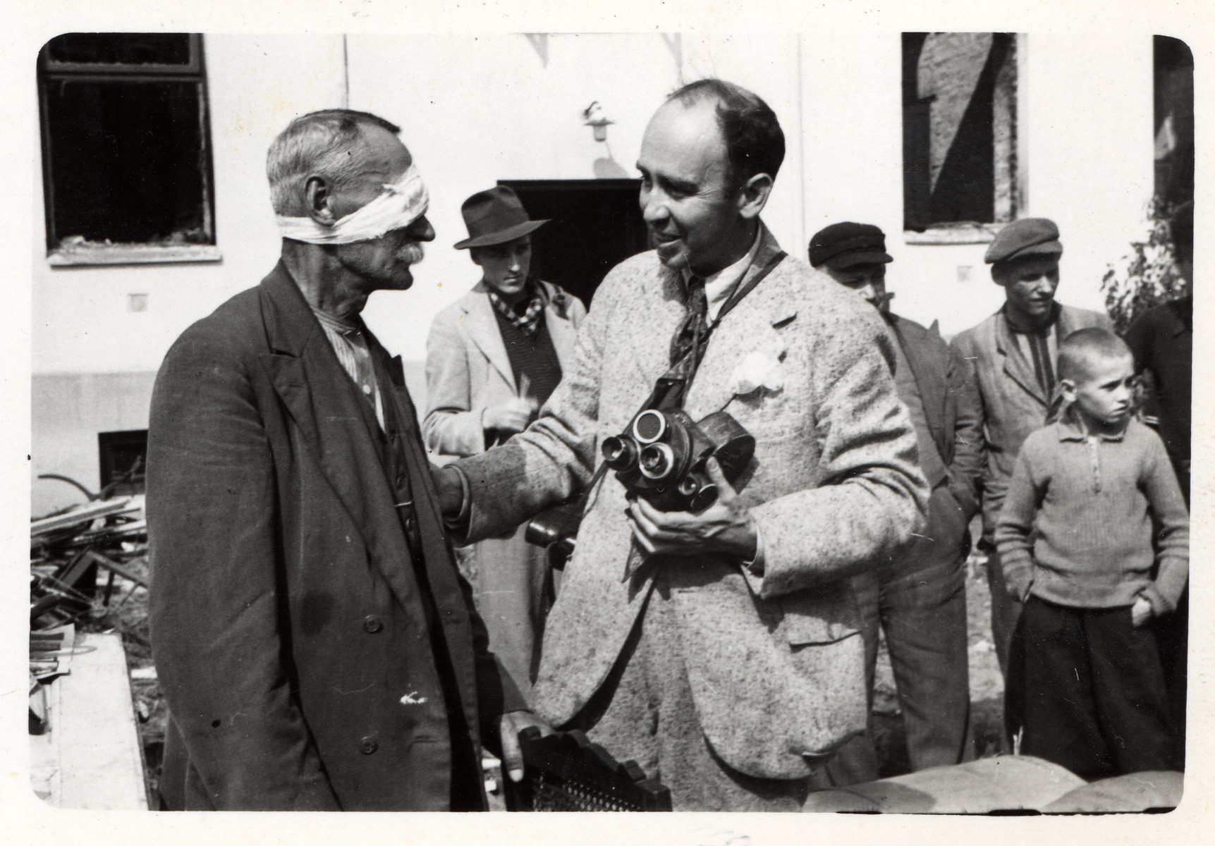 Julien Bryan speaks to a wounded Polish civilian.