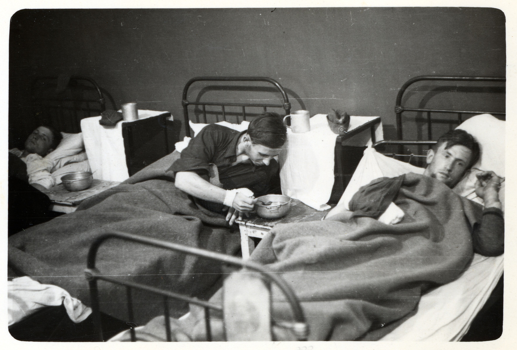 Wounded German POWs rest in a makeshift hospital in besieged Warsaw.