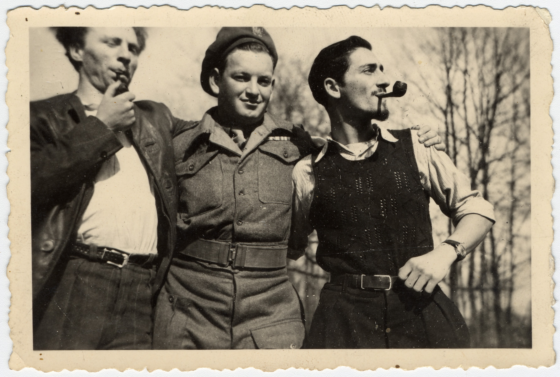 Close-up portrait of three young Israeli men smoking pipes.

Pictured on the right is Jacques Sephiha.  The man in the center is a member of the Jewish Brigade.