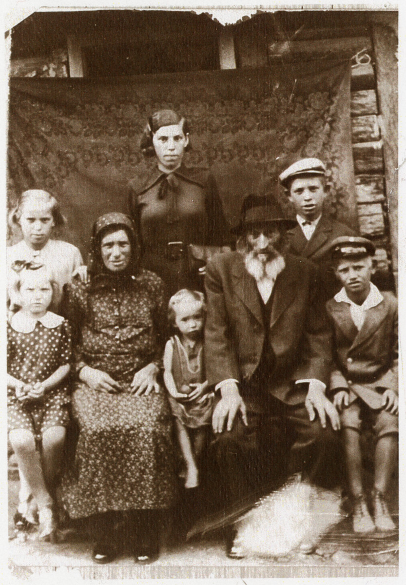 There Berkowitz family poses for a family portrait outside its's home.

Pictured seated left to right:  Mindya Berkowitz, Fradel Berkowitz, Chana Sura Berkowitz, Eliyah Berkowitz, Meyer Berkowitz.  Standing, left to right:  Rosie Berkowitz, Toby Berkowitz, Herschel Berkowitz.