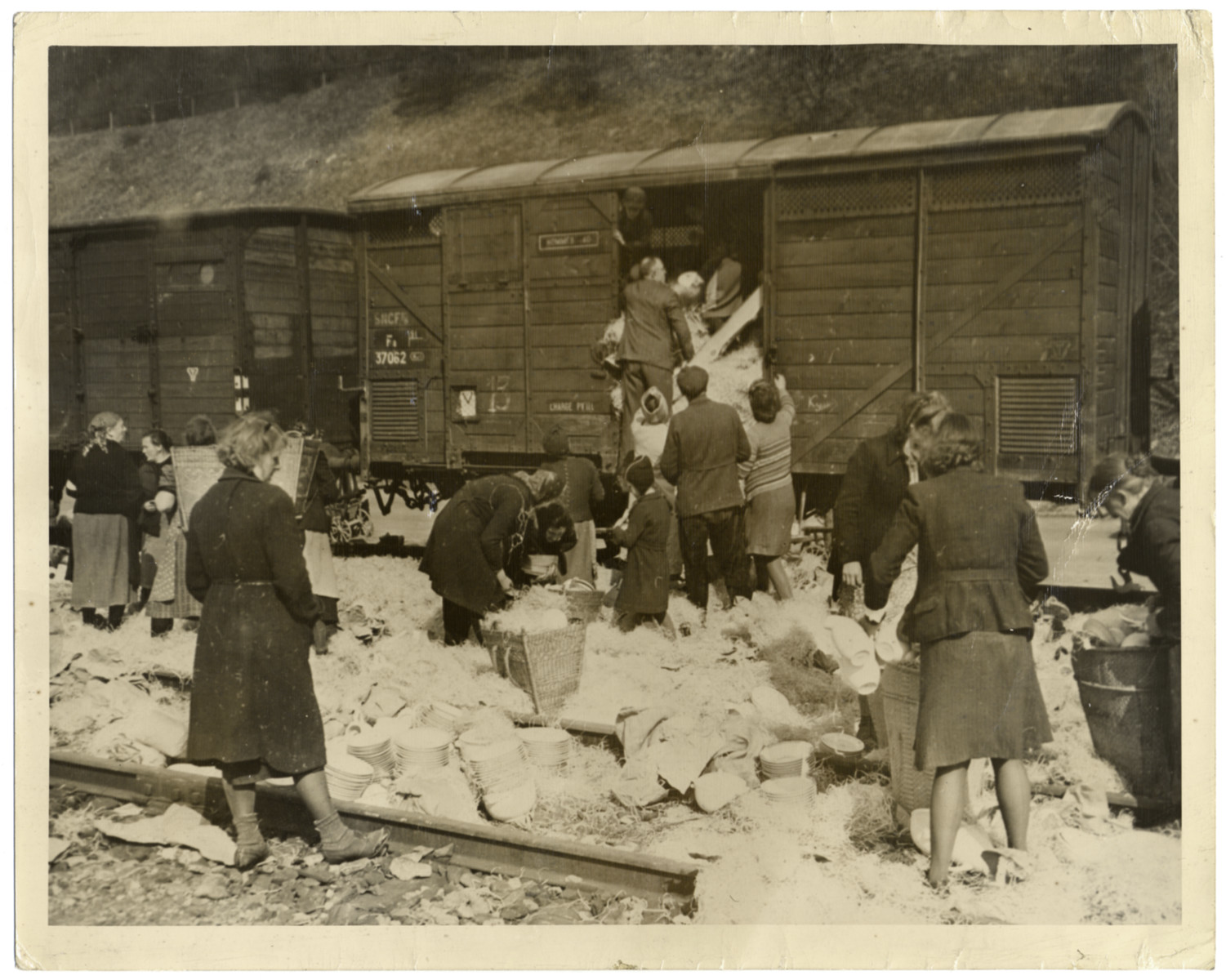 German civilians loot a Nazi train as the war winds down.

Original caption reads: "Civilians, mostly  women loot china from a Nazi freight car halted in railyards near Elsenoch, historic German town captured April 6, 1945, by troops of the Third U.S Army. Throughout  captured portions of the Reich, the fleeing of Gestapo members is the signal for German civilians, mostly women, to loot shops, trains, bombed houses and warehouses.
U.S Signal Corps Photo ETC-HQ-45-61632"