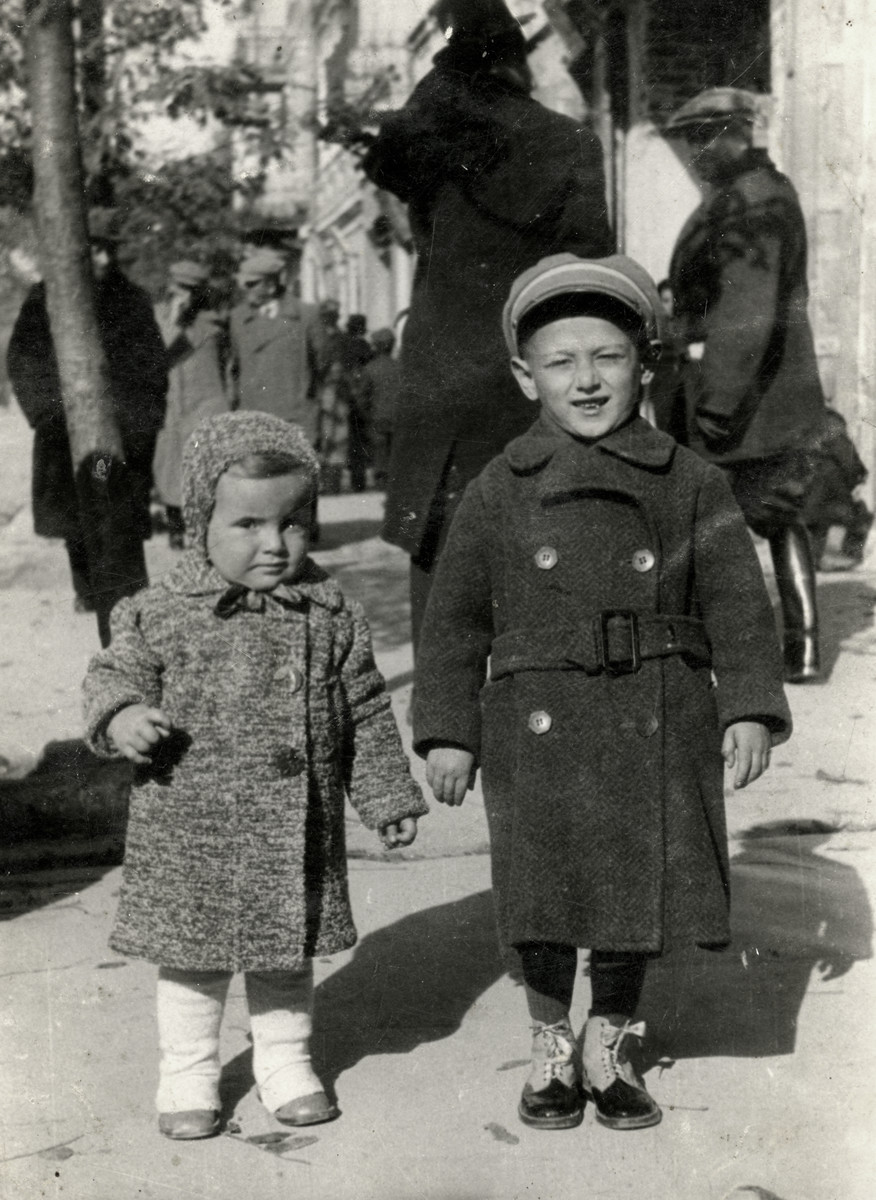 Zvia Korenzyer and her cousin walk down a street in Chelm, Poland.