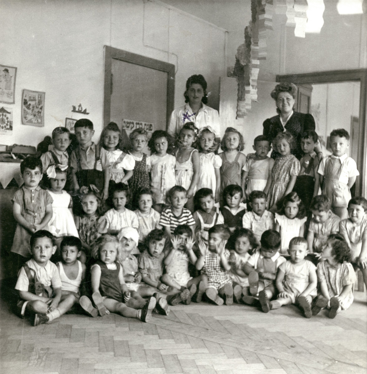 Group portrait of young children in the Schlachtensee kindergarten.

Clara Finkelstein is standing in the last row of children, 6th from the left.  Also pictured are Manny Porth (back row, far right) and his younger  brother Eli Porth (back row, fourth from the right)