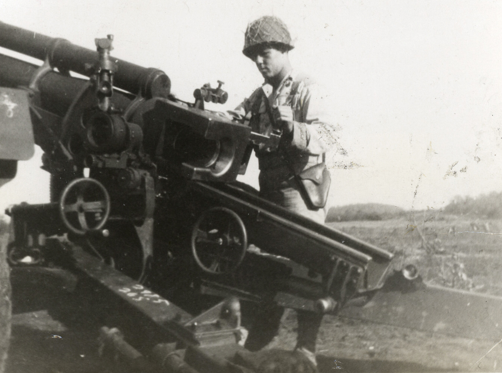 American Jewish soldier Hilbert Margol loads his artillery piece.
