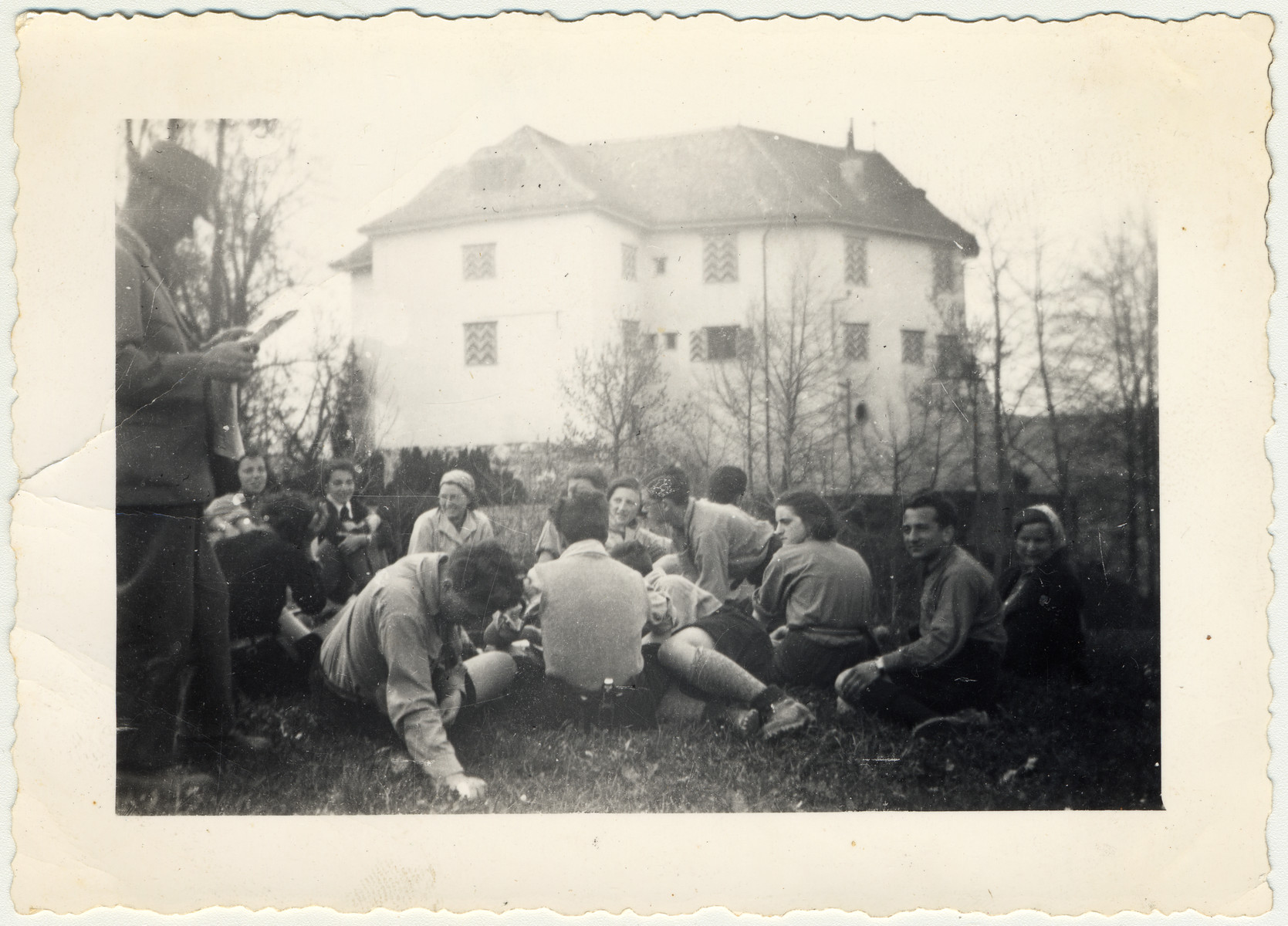 Zionist youth relax in the grass after work at Schloss von Elgg.