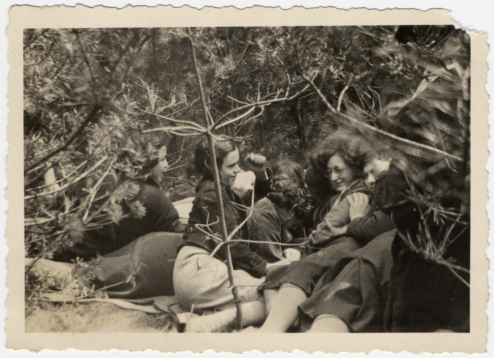 A group of Zionist teeange girls rest during an excursion in the woods.

The orignal caption reads "en route to freedom."