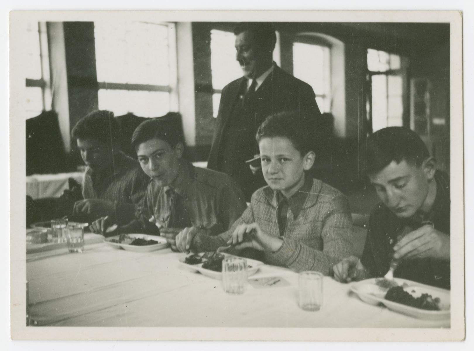 An Austrian boy scout troop shares a meal.

Hans Morawetz is pictured in the center.