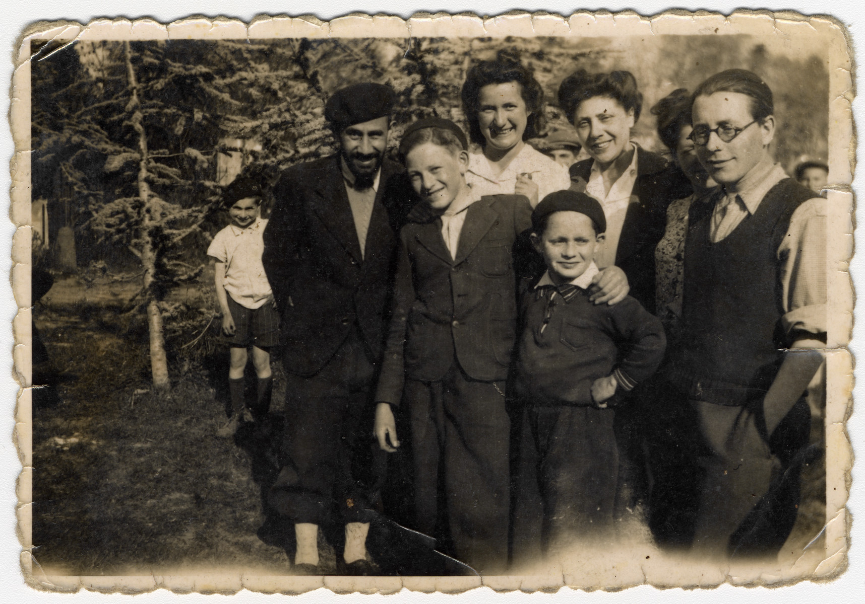 Group portrait of staff and children from the Chateau des Morelles children's home.

Pictured in front are Raphael and Markus Horowitz.  Standing left to right are Mr. Amsel, Myriam (Weichselbaum) Dybnis, Mrs. Brown, and [possibly Henry Dybnis].