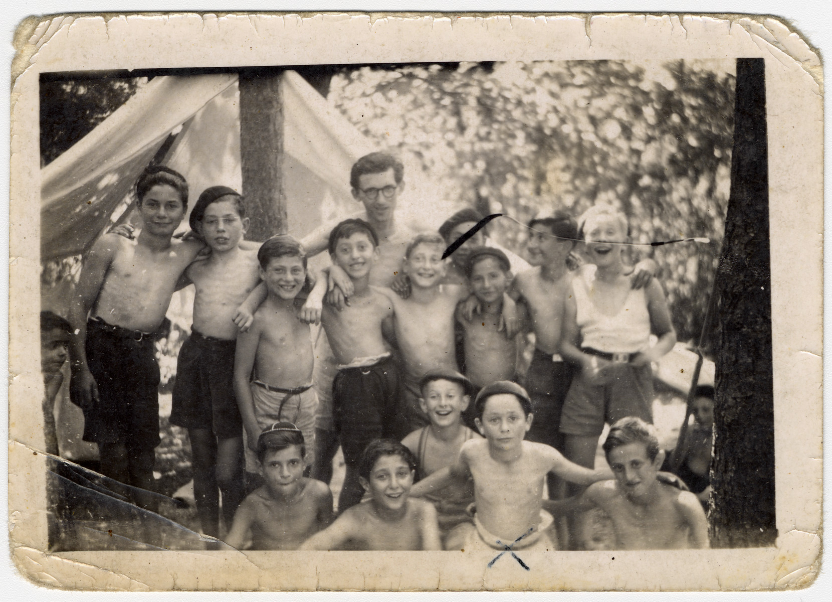 Group portrait of children from the Chateau des Morelles next to a tent in the woods.

Markus Horowitz is pictured in the front row, second from the right.  Henri Dybris, a teacher, is standing in the back, center.