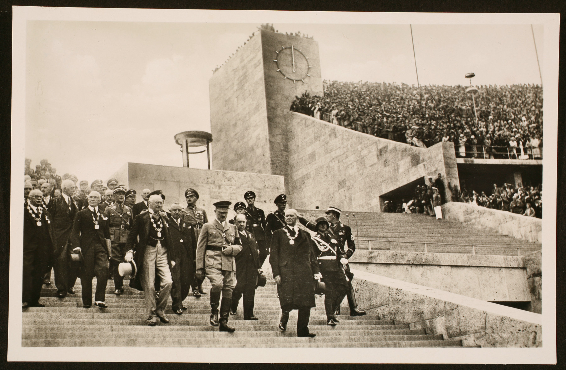 Hitler descends the stairs of the Olympic Stadium with several members of the International Olympic Committee, including Dr. Theo Lewald (R) and Henri de Baillet-Latour, the IOC president (L), to open the 11th Olympic Games.