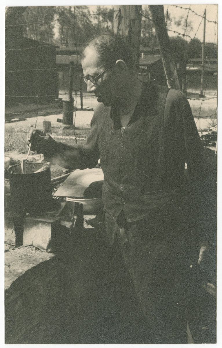 A survivor of either Ohrdruf or Buchenwald concentration camp prepares a light meal after liberation.