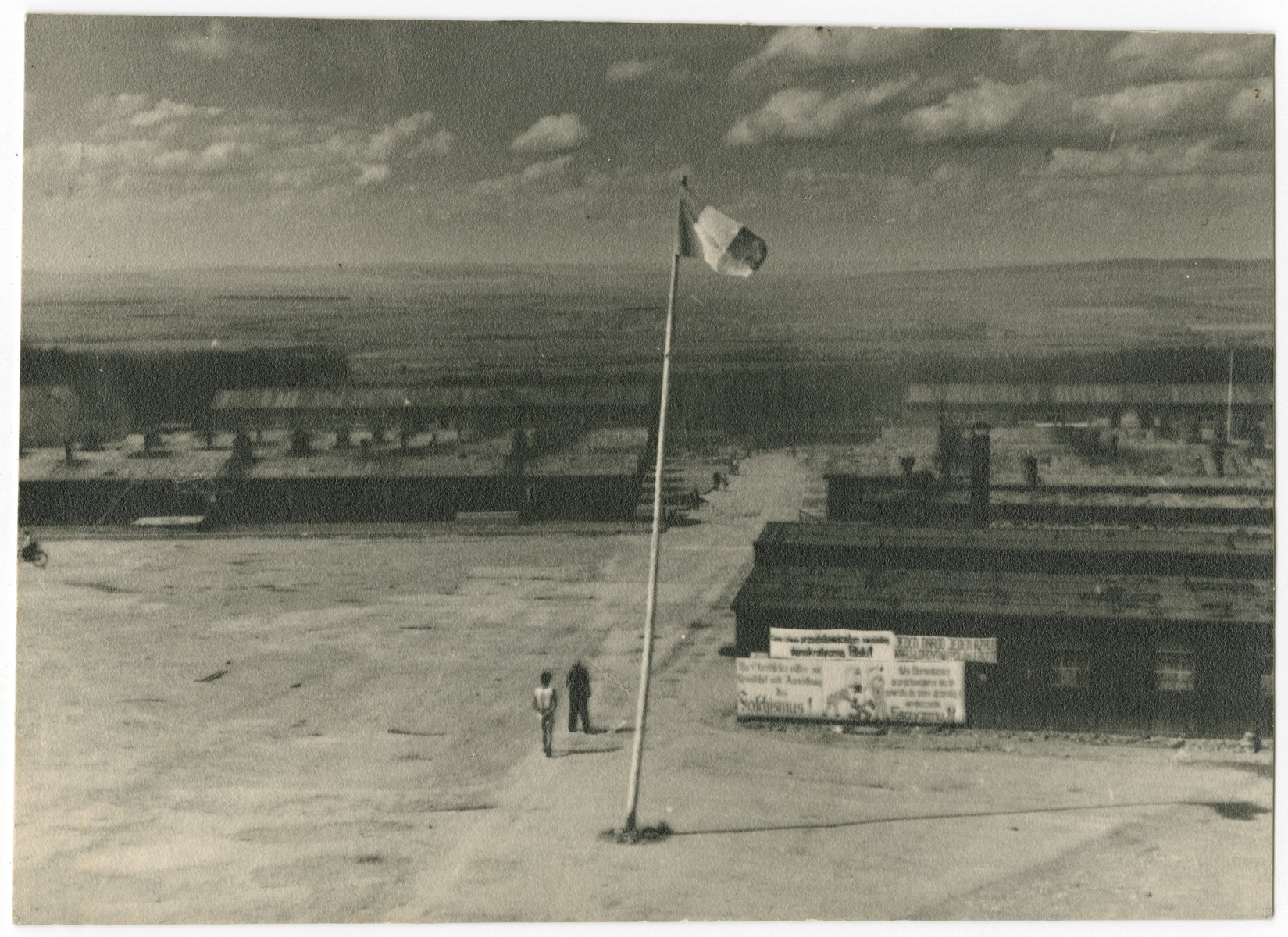 An allied flag [probably French] flies in the central courtyard of the Buchenwald concentration camp following liberation.