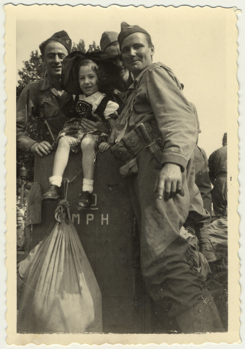 Soldiers pose with a young girl during the liberation of France. 

Original caption reads: "Paris, Sept. 1944, The Liberation."