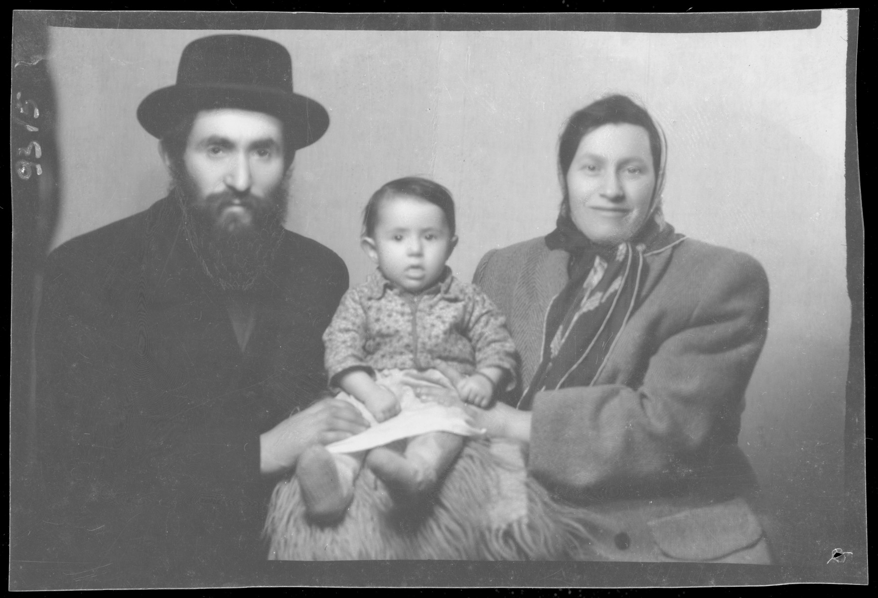 Studio portrait of Salamon Geriner, his wife and child.