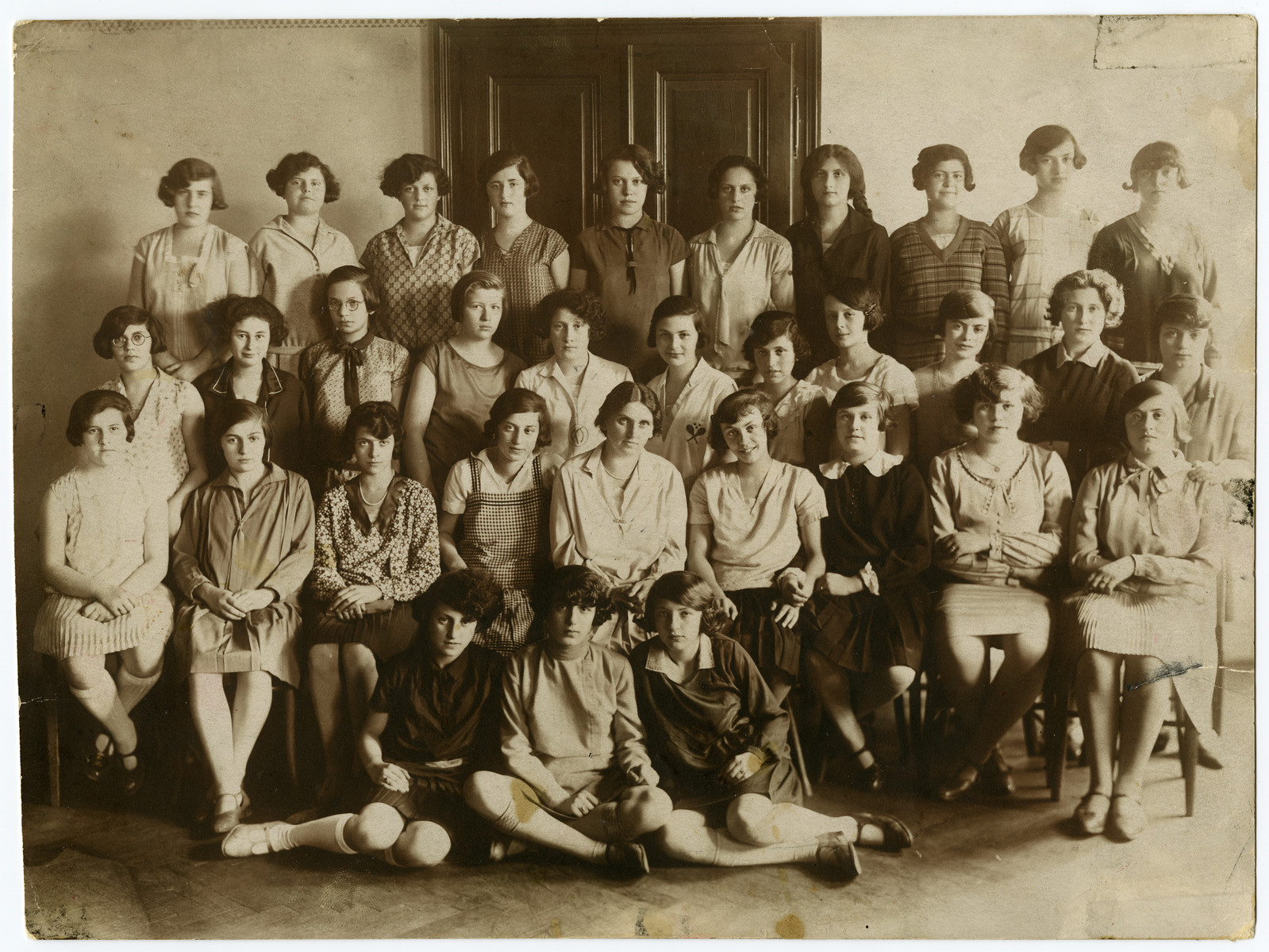 Group portrait of teenage girls in a school in Vienna.

Dora Austein in pictured in the front, middle.